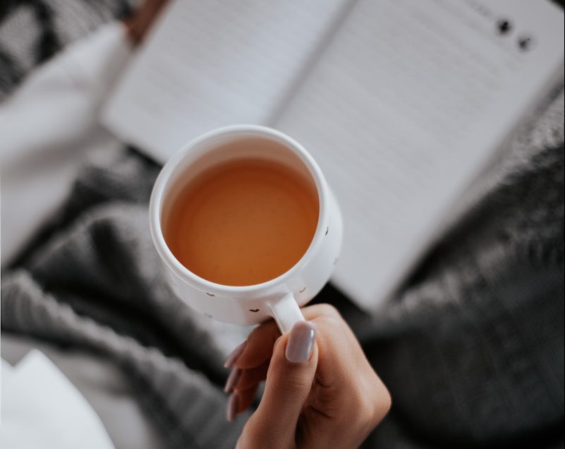 person holding white ceramic mug