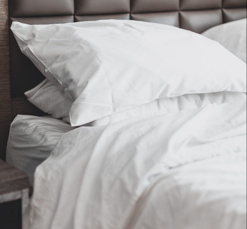 white bed pillow on bed